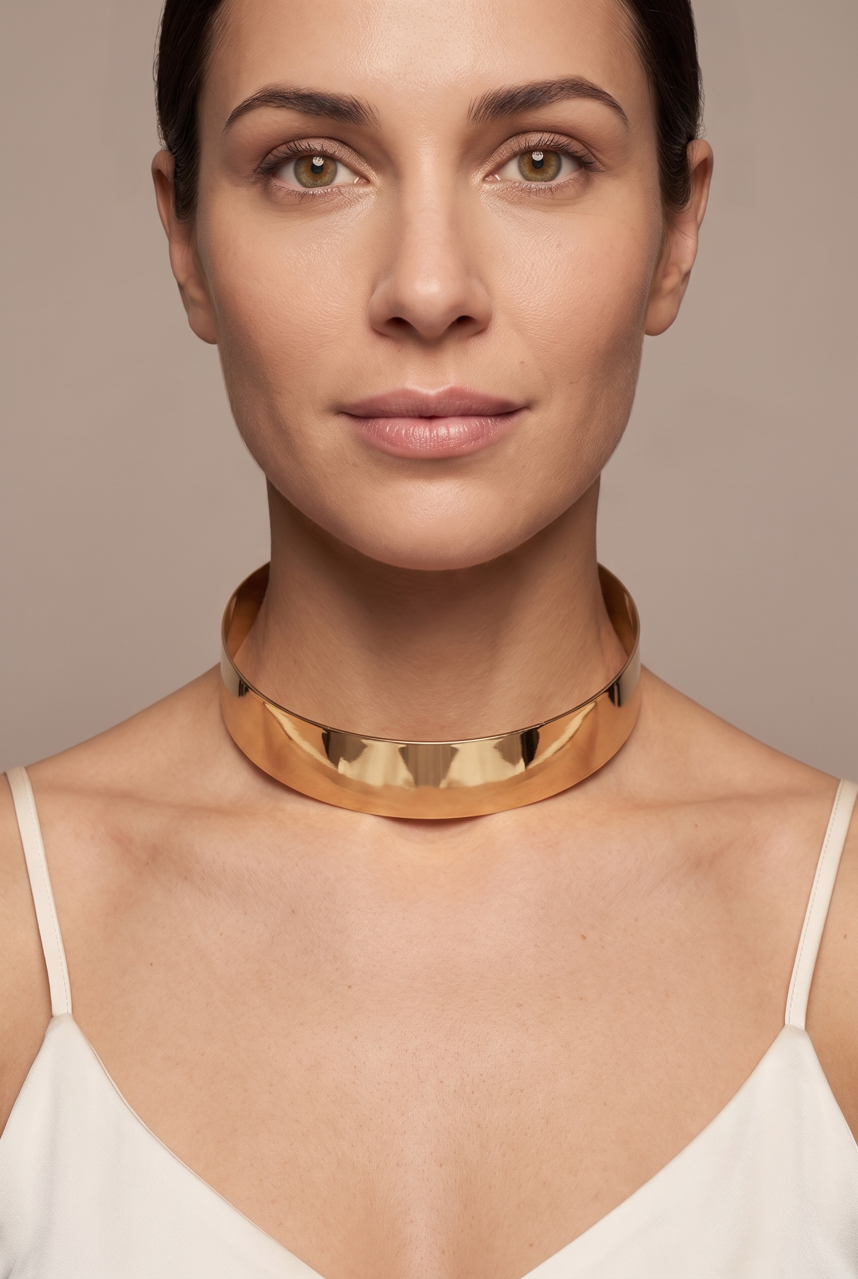 Plain polished torque collar in gold worn on the neck
