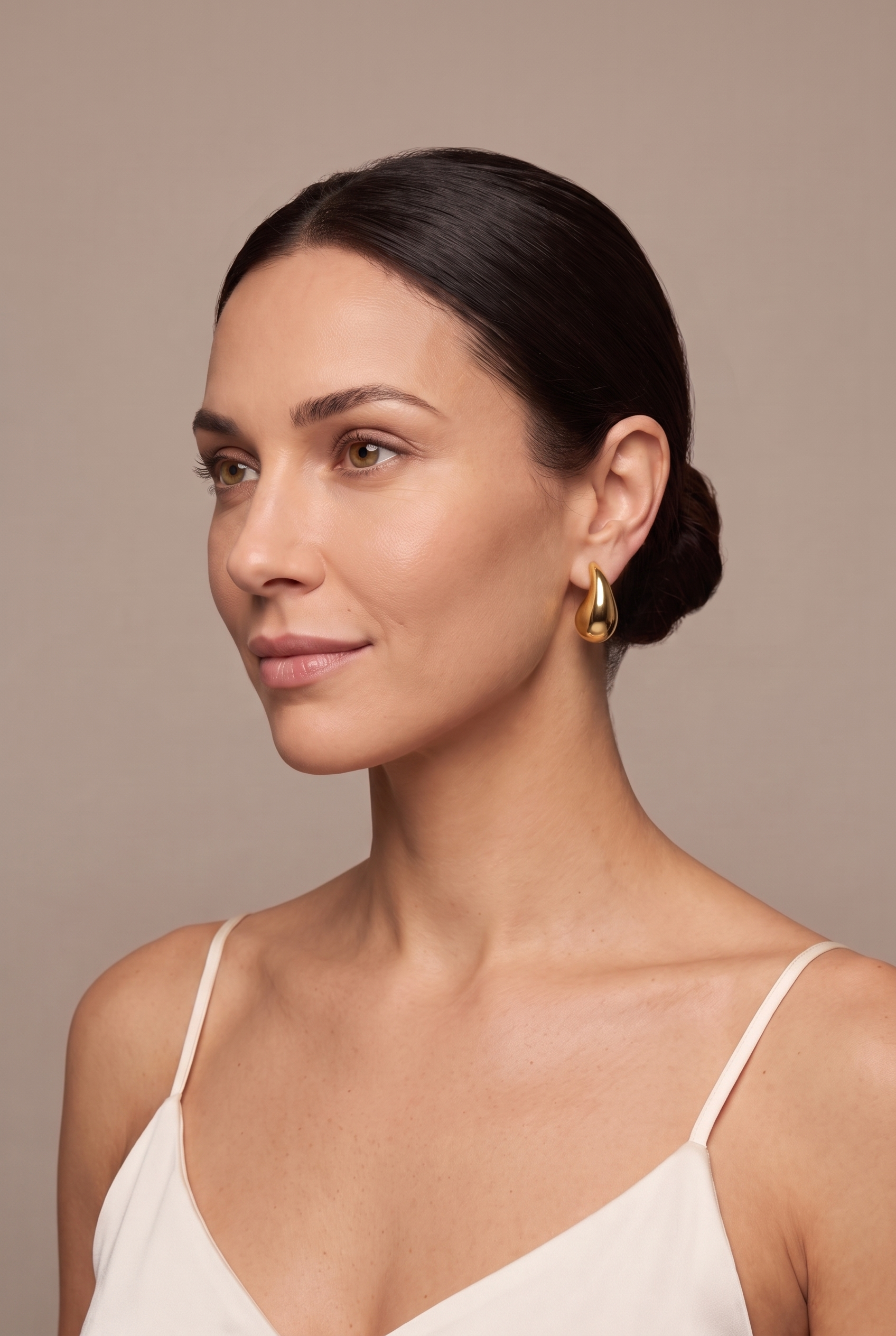Small chunky teardrop drop stud in gold worn on the ear